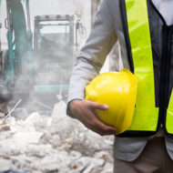 Construction worker holding helmet